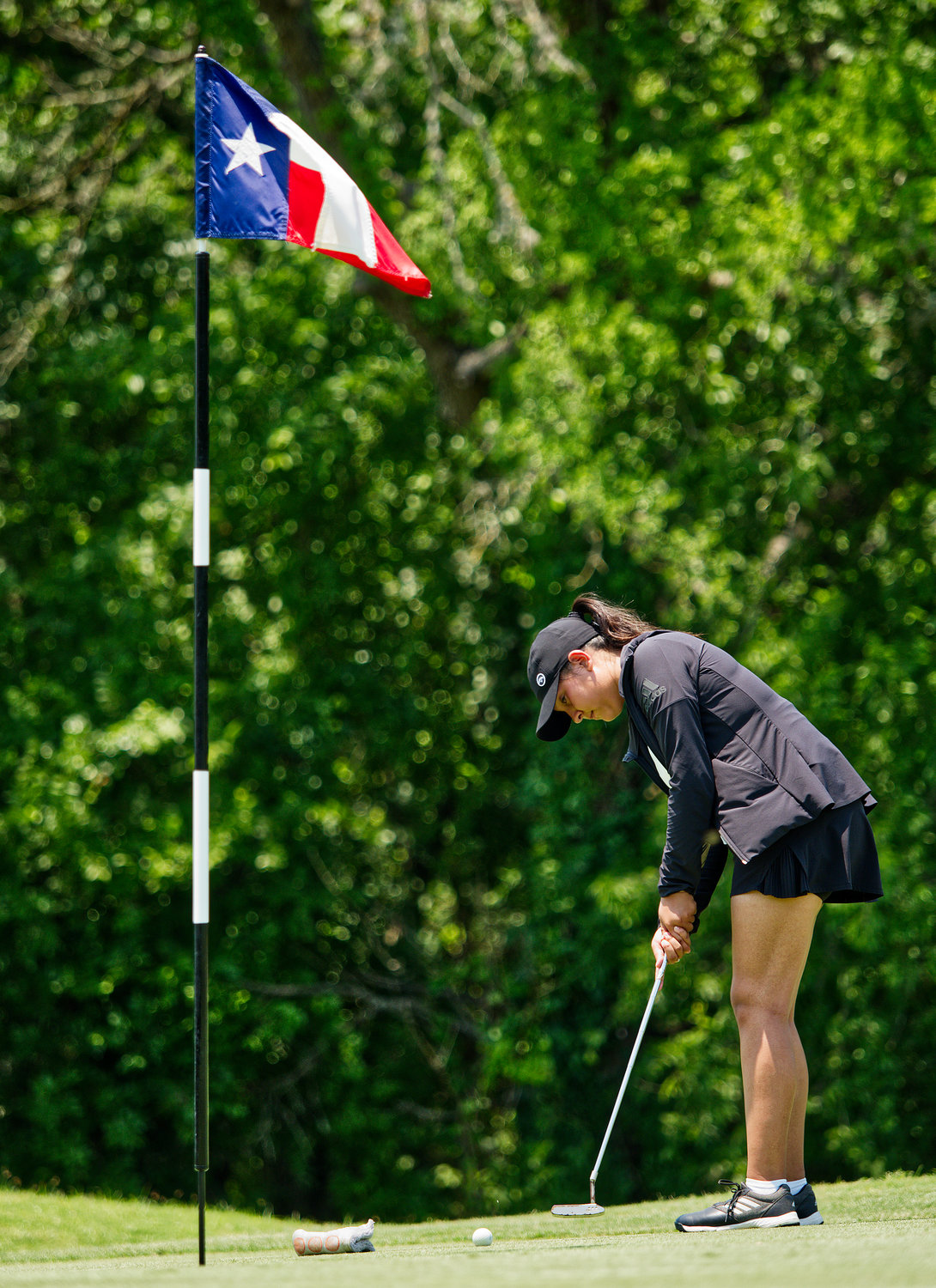 Savannah Lopez putts during her back nine of the opening round Monday afternoon. [see more orange on greens]